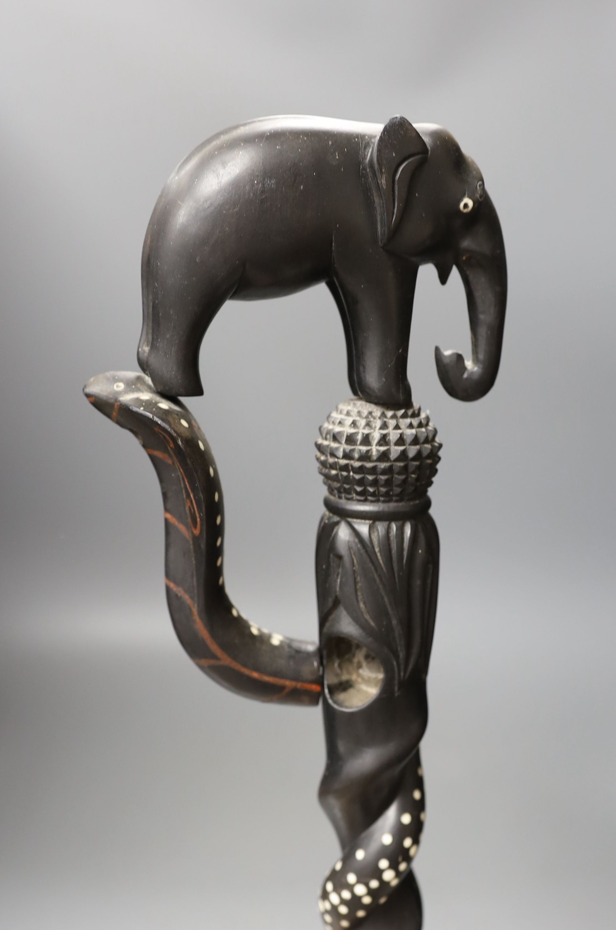A late 19th/early 20th century Ceylonese carved ebony ‘elephant’ walking stick, 90cm